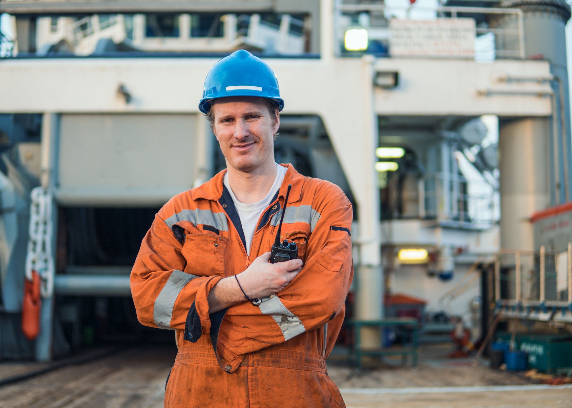 Marine Deck Officer or Chief mate on deck of ship with VHF radio